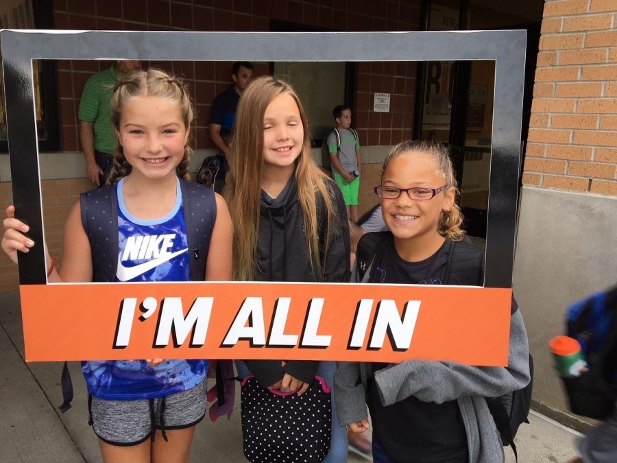 people holding a frame sign